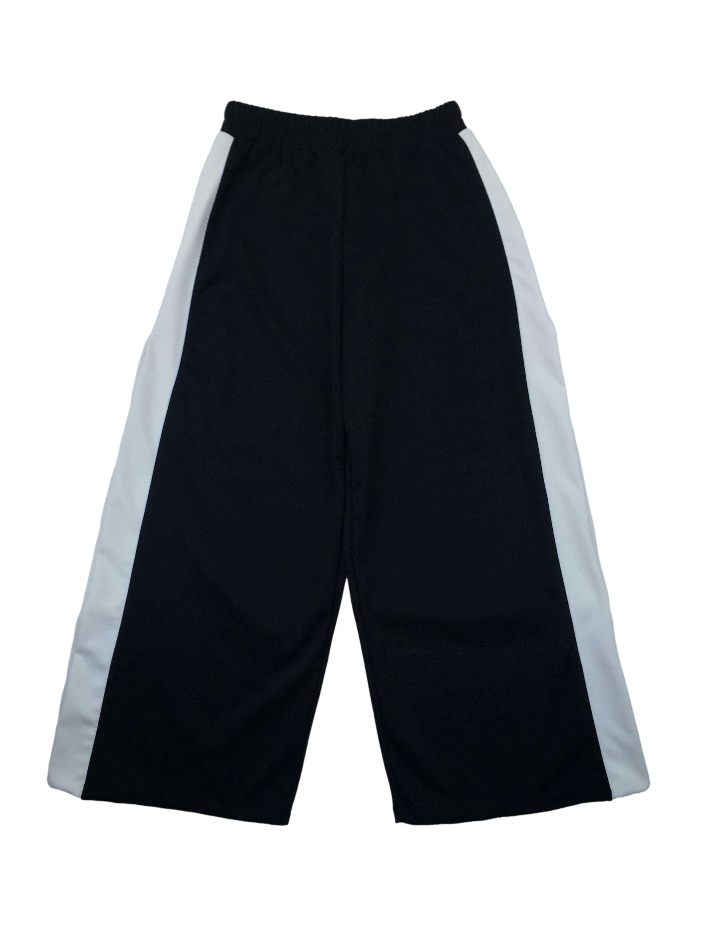 Pantalón La Matier tipo buzo negro con franjas blancas, abertura en los laterales, elástico en la cintura. Cintura: 70cm (sin estirar), Tiro: 33 m, Largo: 95cm