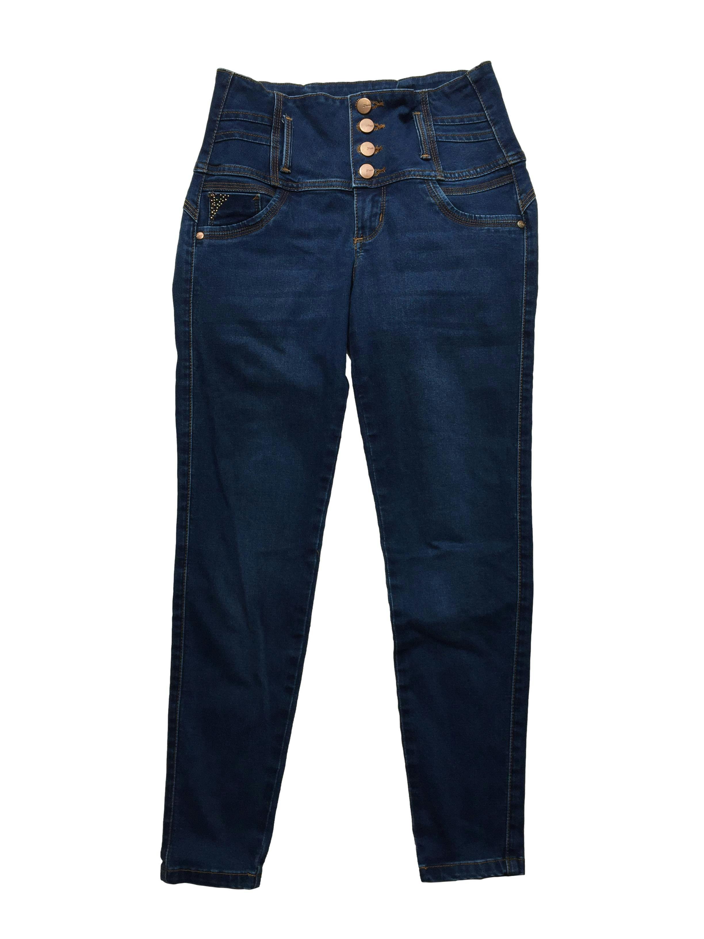 Skinny jean azul de tiro alto, pretina ancha y falsos bolsillos. Cintura 70cm, Largo 90cm.