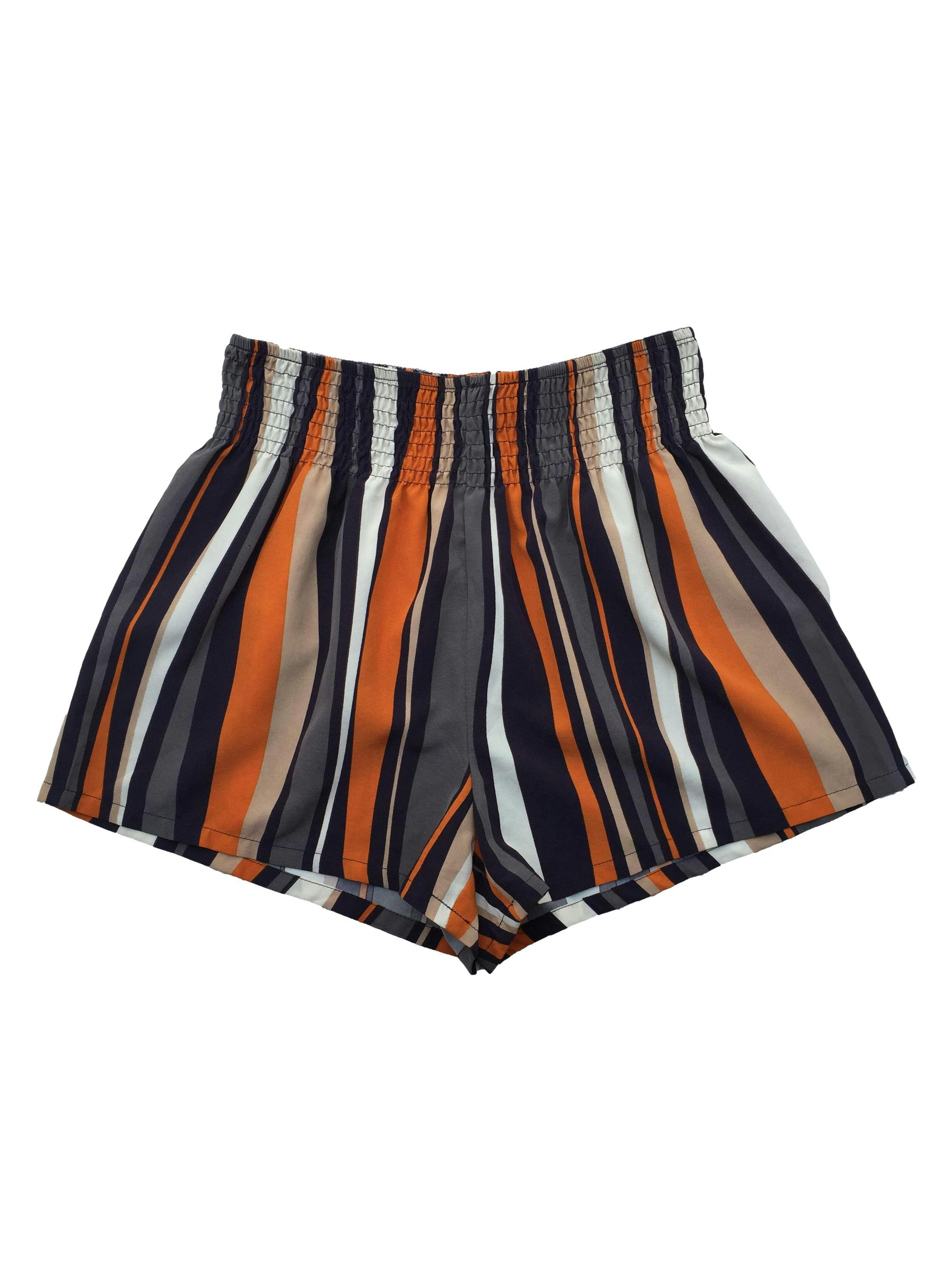 Short de líneas azul. gris, naranja, beige y pretina en la cintura. Cintura: 68 (sin estirar), Tiro: 32cm, Largo: 33cm